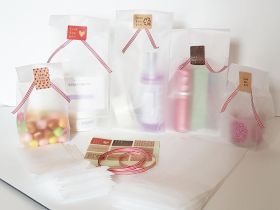 Pack of 20  Small clear frosted block bottom sweet/party/ gift bags (3" x 2" x 7") with assorted "just for you" sticky labels and red/white cotton ribbon