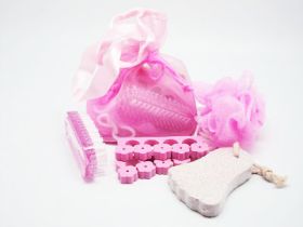 4 small bath spa items in a light pink toiletry bag with string tie (sponge, pumice stone, hand brush and toe separator)